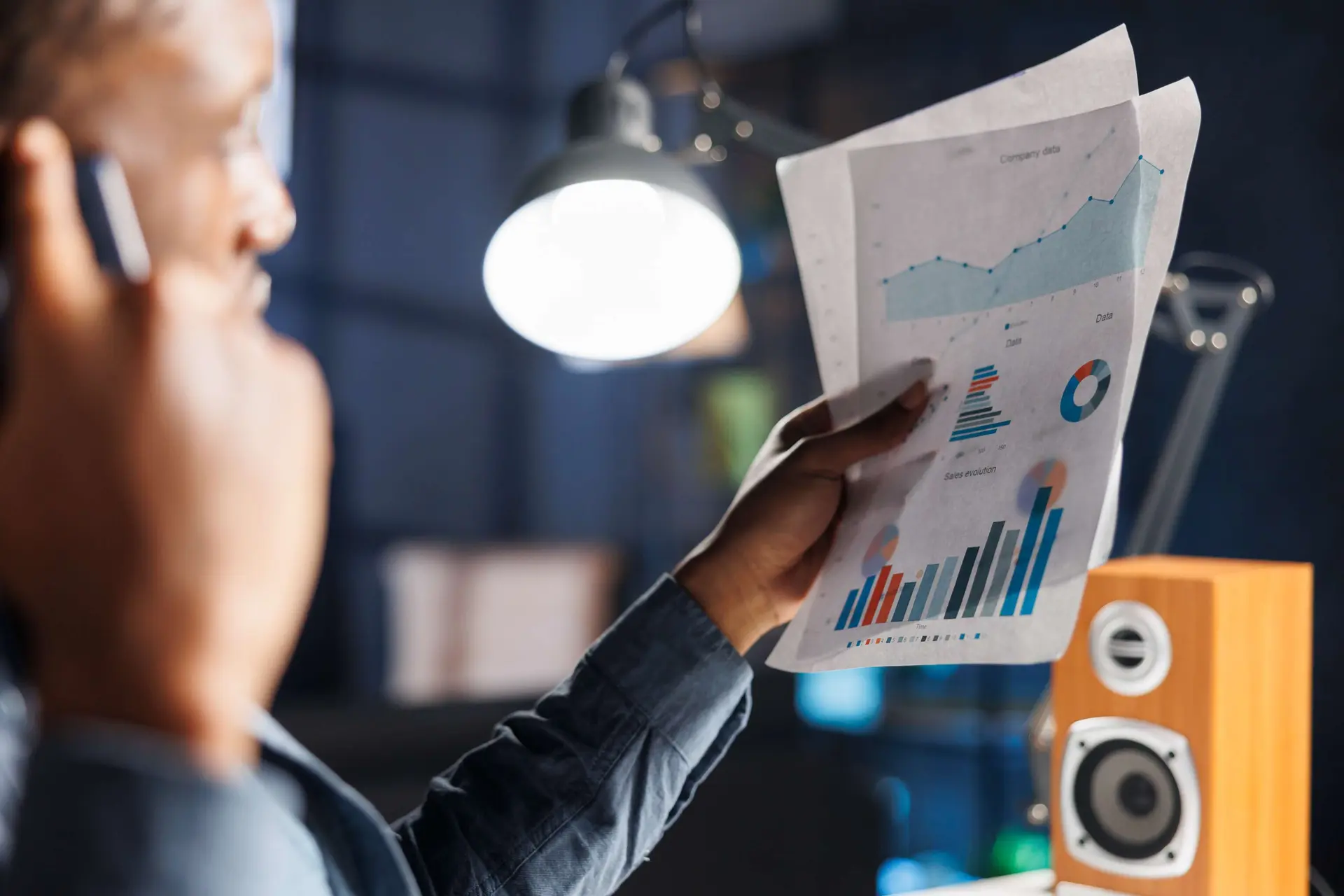 Telecom analyst reviewing cost charts exposing structural legacy system expenses squeezing operator margins